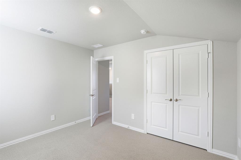 1636 Arches Road Anna, TX 75409 - Photo 19 of 22 an empty room with white cabinet and closet