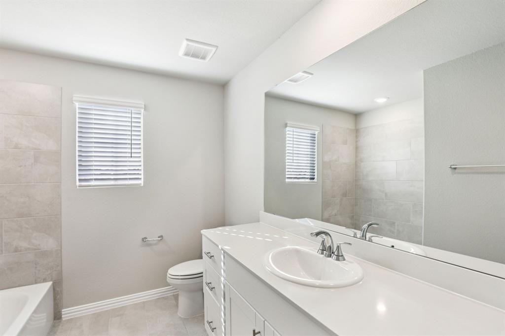 1636 Arches Road Anna, TX 75409 - Photo 20 of 22 a bathroom with a sink a toilet and mirror