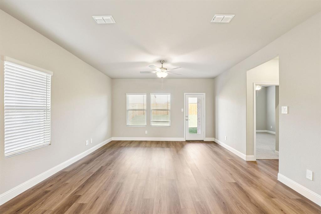 1636 Arches Road Anna, TX 75409 - Photo 8 of 22 a view of an empty room with wooden floor and a window