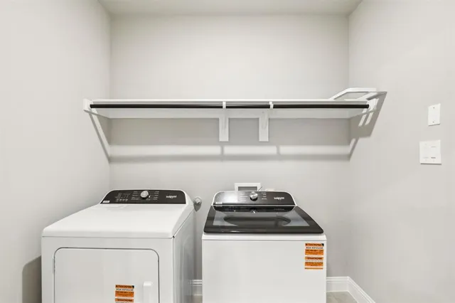 a view of storage and utility room with washer and dryer