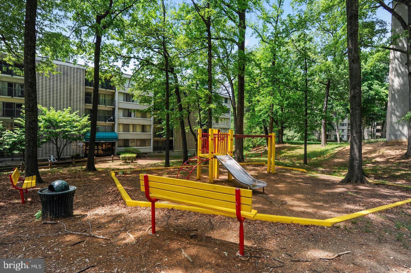 1804 Metzerott Road, Unit 303 Hyattsville, MD 20783 - Photo 13 of 13 a view of a park with large trees and a bench