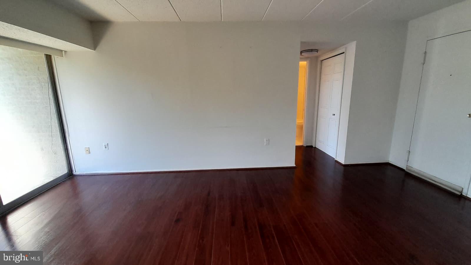1804 Metzerott Road, Unit 303 Hyattsville, MD 20783 - Photo 3 of 13 a view of a room with wooden floor and bench