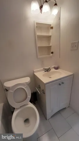 a bathroom with a sink toilet and mirror