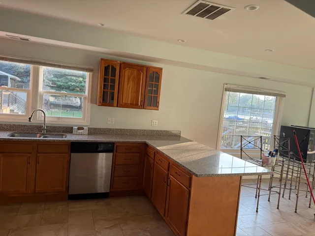 a kitchen with granite countertop a sink and cabinets