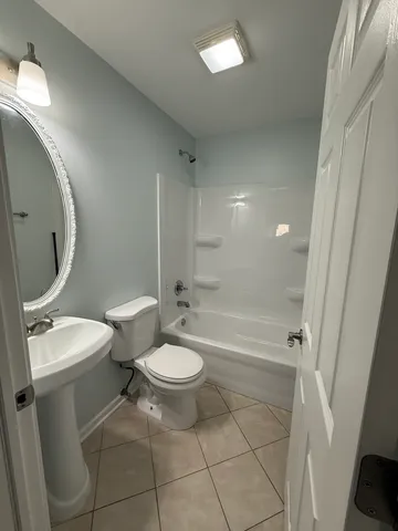 a bathroom with a toilet a sink and bathtub