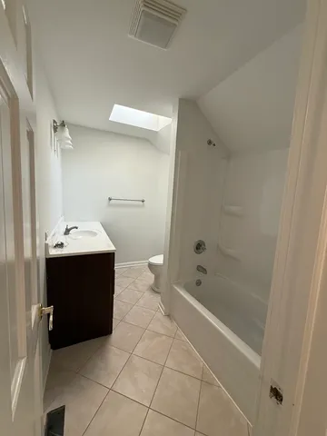 a bathroom with a bathtub and a sink