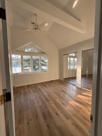 wooden floor in an empty room with a window