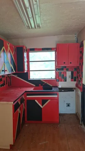 a kitchen that has a sink and a stove