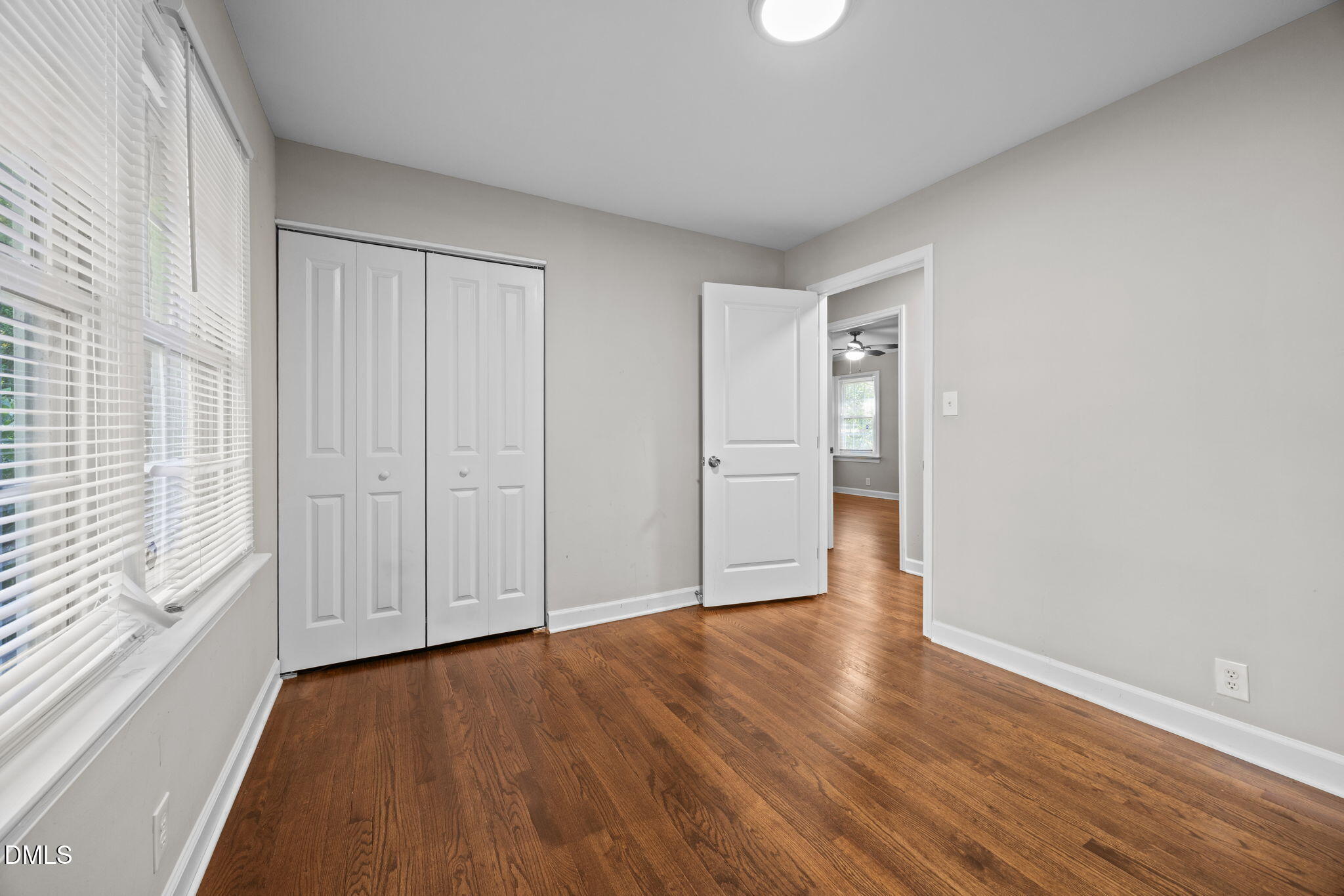 2950 Glenridge Drive Raleigh, NC 27604 - Photo 32 of 53 a view of an empty room with wooden floor and a window