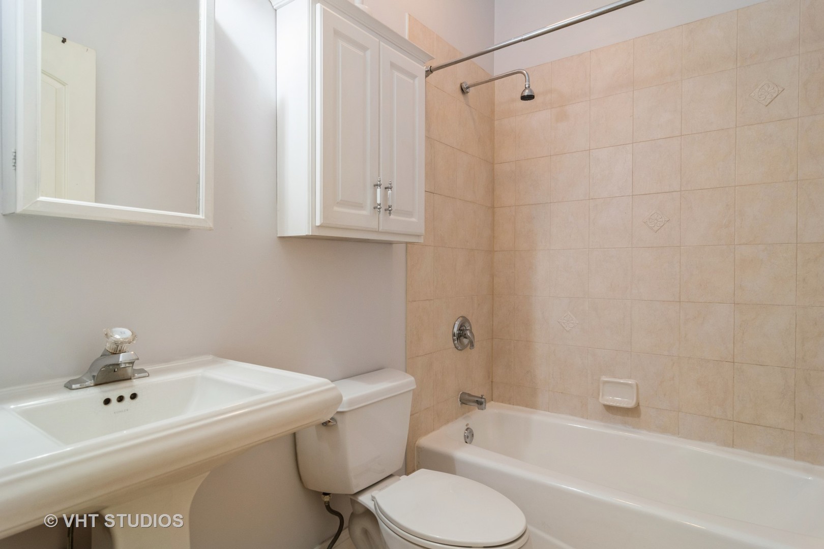 1939 West Division Street, Unit R2 Chicago, IL 60622 - Photo 14 of 18 a white bath tub sitting next to a white toilet and sink