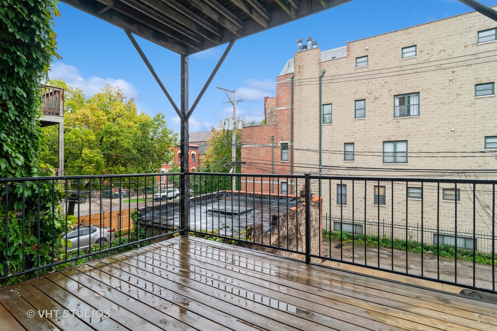 1939 West Division Street, Unit R2 Chicago, IL 60622 - Photo 16 of 18 a view of a balcony with wooden floor and fence