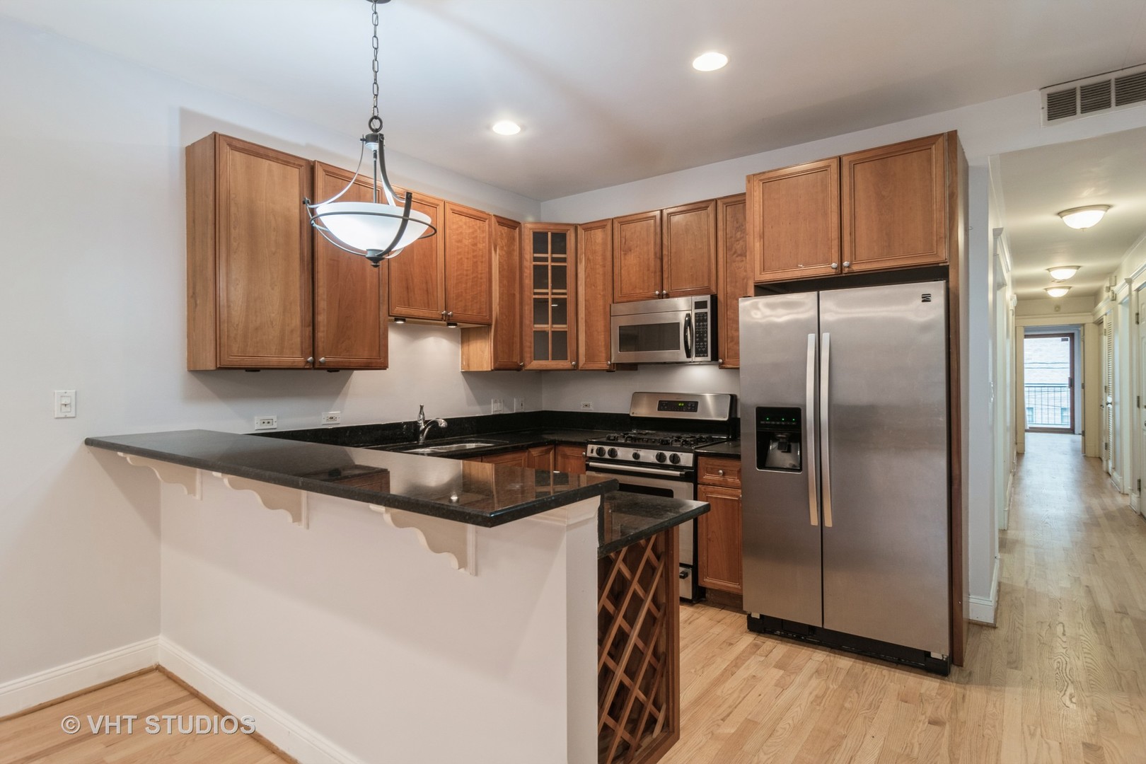 1939 West Division Street, Unit R2 Chicago, IL 60622 - Photo 7 of 18 a kitchen with stainless steel appliances granite countertop a stove a refrigerator a sink and a microwave