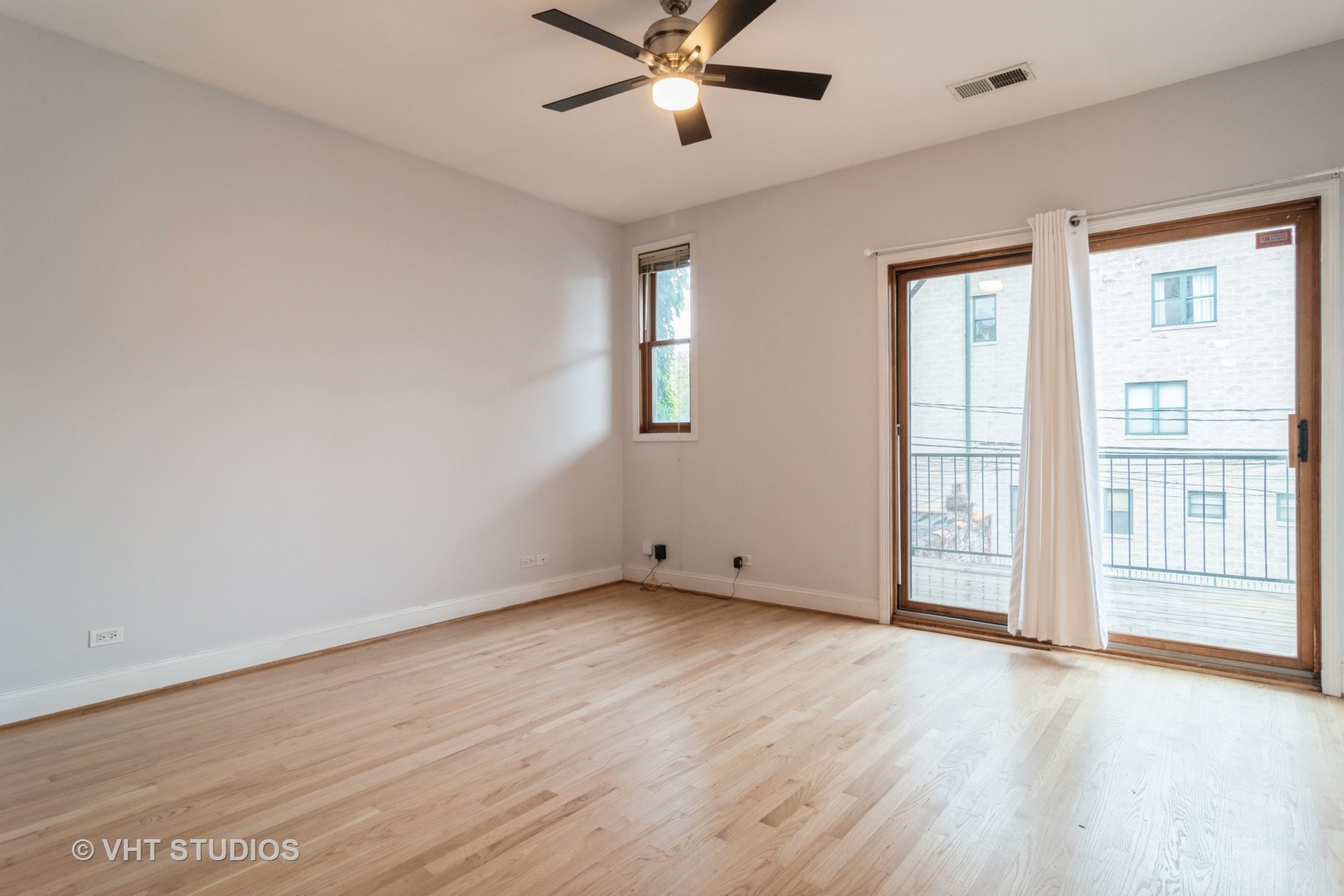 1939 West Division Street, Unit R2 Chicago, IL 60622 - Photo 8 of 18 an empty room with wooden floor fan and windows