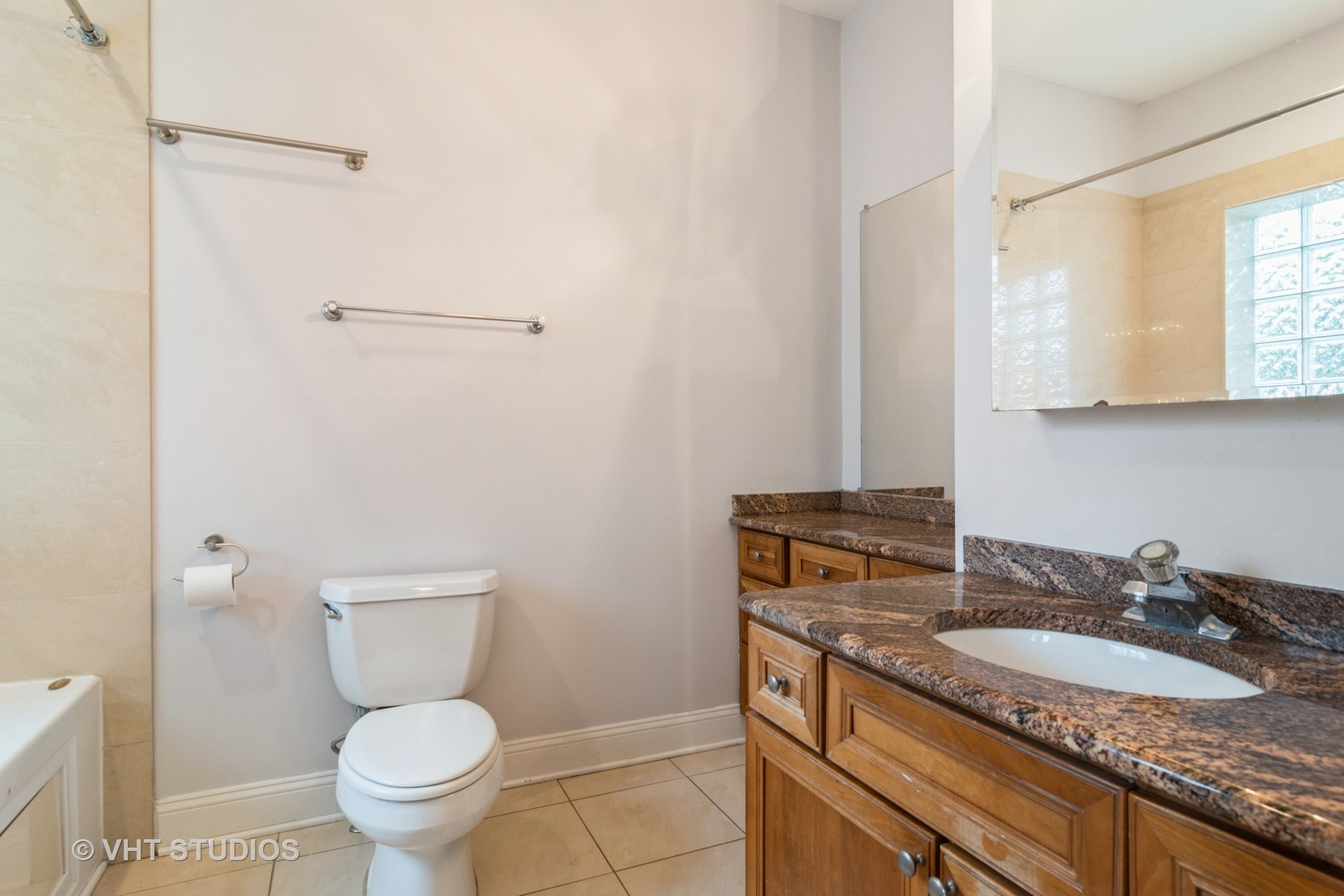 1939 West Division Street, Unit R2 Chicago, IL 60622 - Photo 10 of 18 a bathroom with a granite countertop toilet sink and mirror