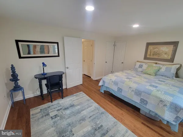 a bedroom with a bed and a desk