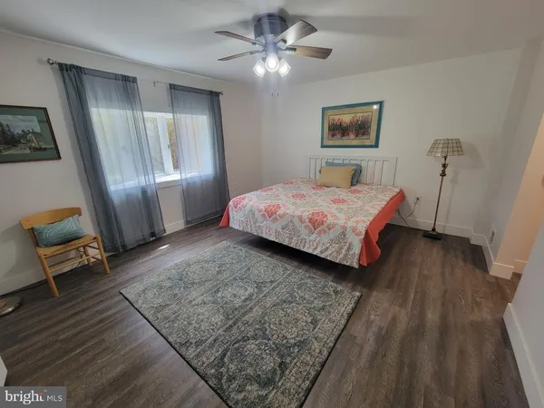 a bedroom with a bed and a mirror