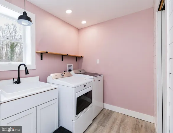 a view of bathroom with a sink and mirror