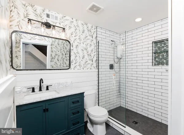 a bathroom with a toilet sink and shower