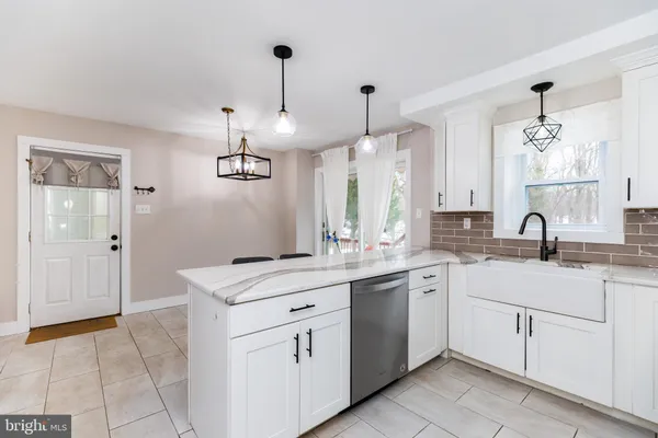 a kitchen with a sink window and cabinets