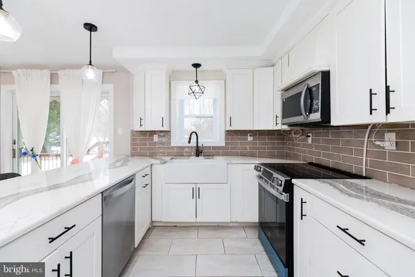 a kitchen with a sink stove and microwave