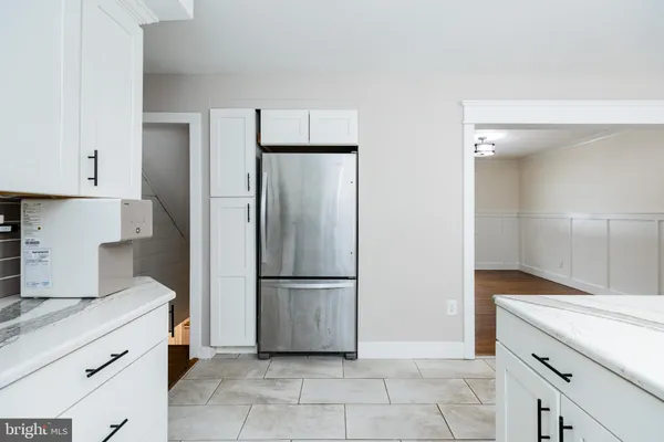a kitchen with a refrigerator and a sink