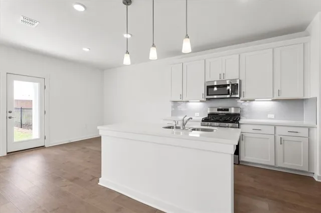 a kitchen with center island and stainless steel appliances