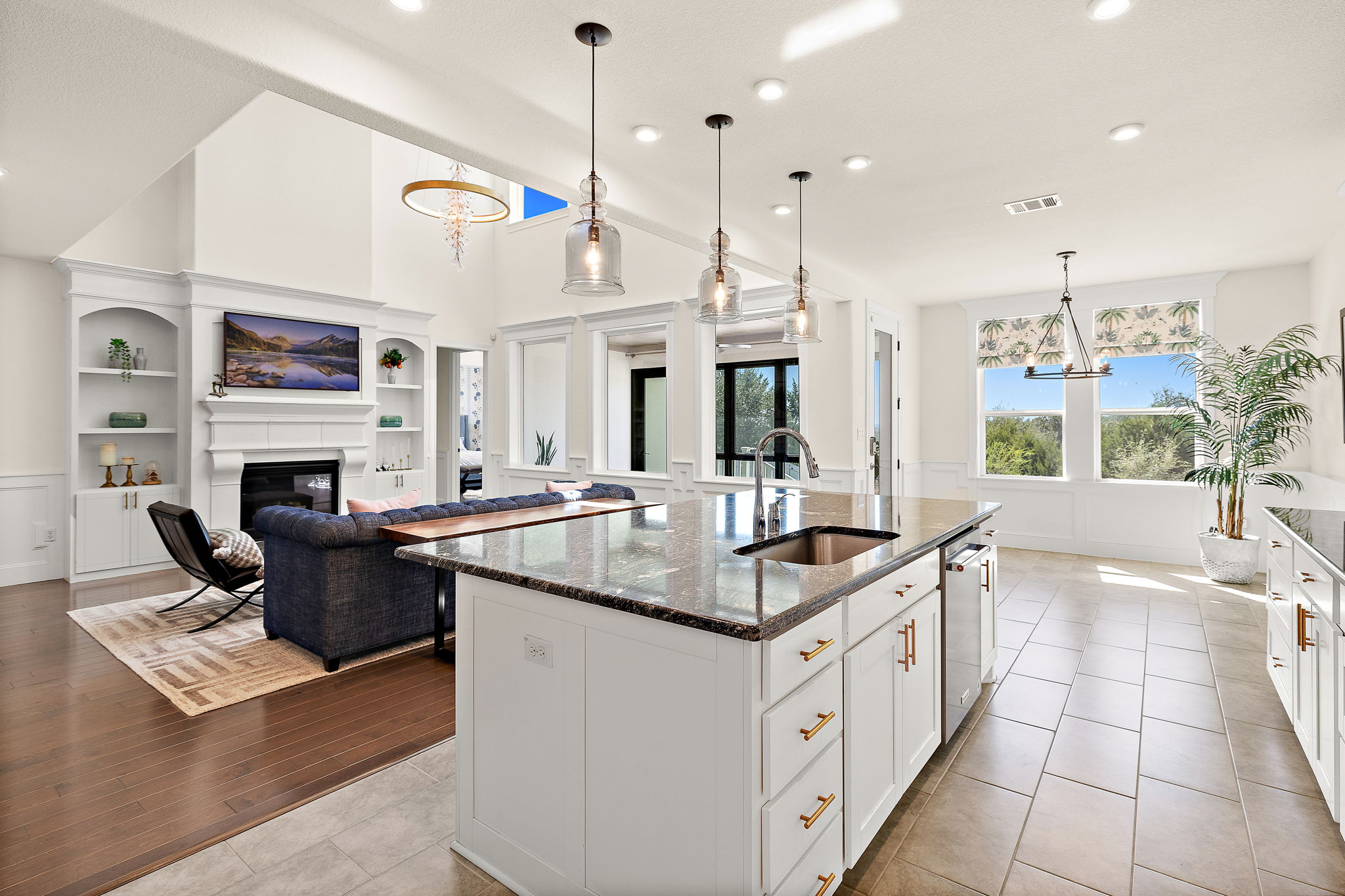 218 Encanto Place Austin, TX 78737 - Photo 12 of 40 a open kitchen with stainless steel appliances granite countertop a stove a sink and a fireplace