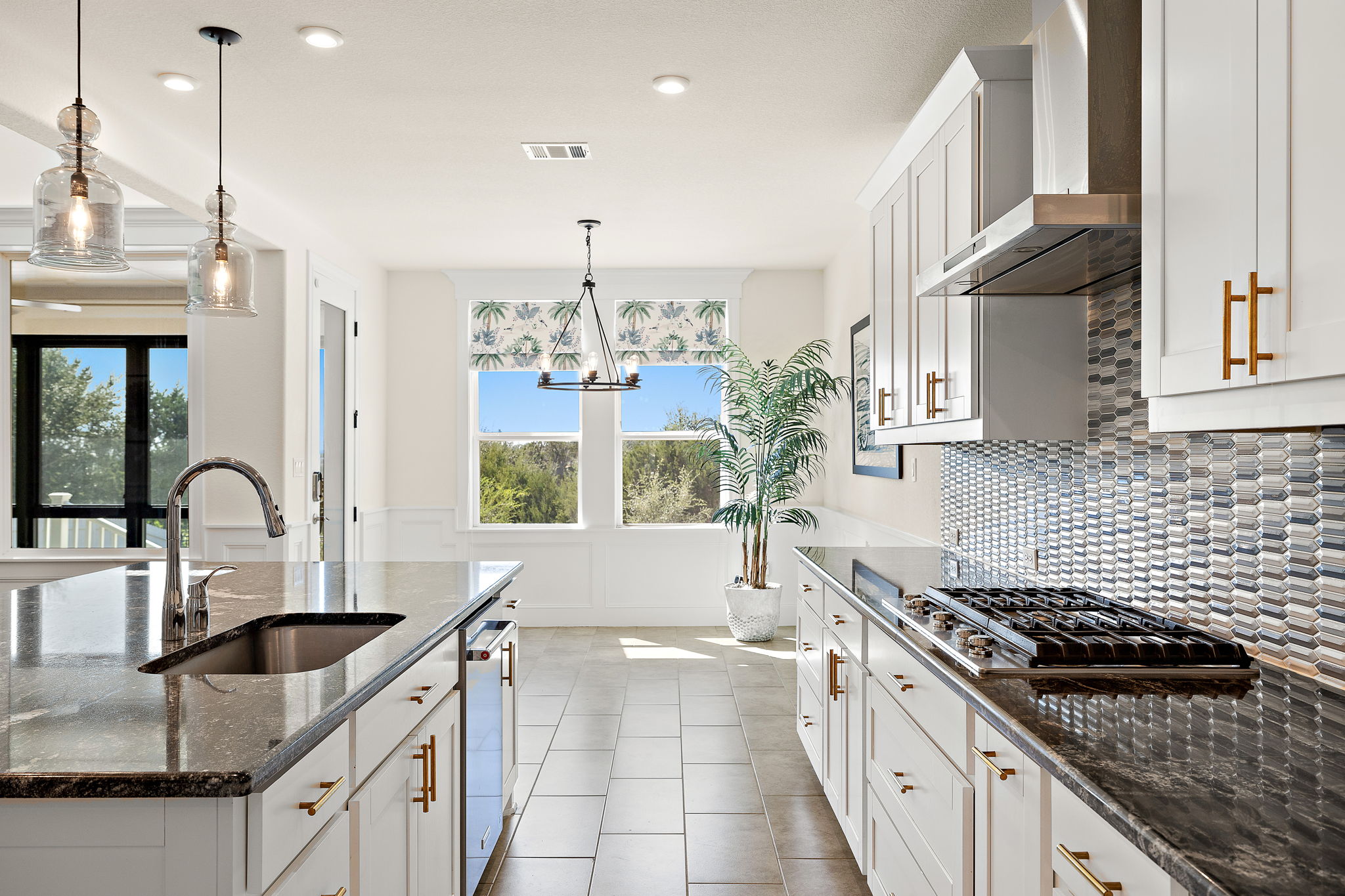 218 Encanto Place Austin, TX 78737 - Photo 13 of 40 a kitchen with stainless steel appliances granite countertop a sink a stove and a wooden floor