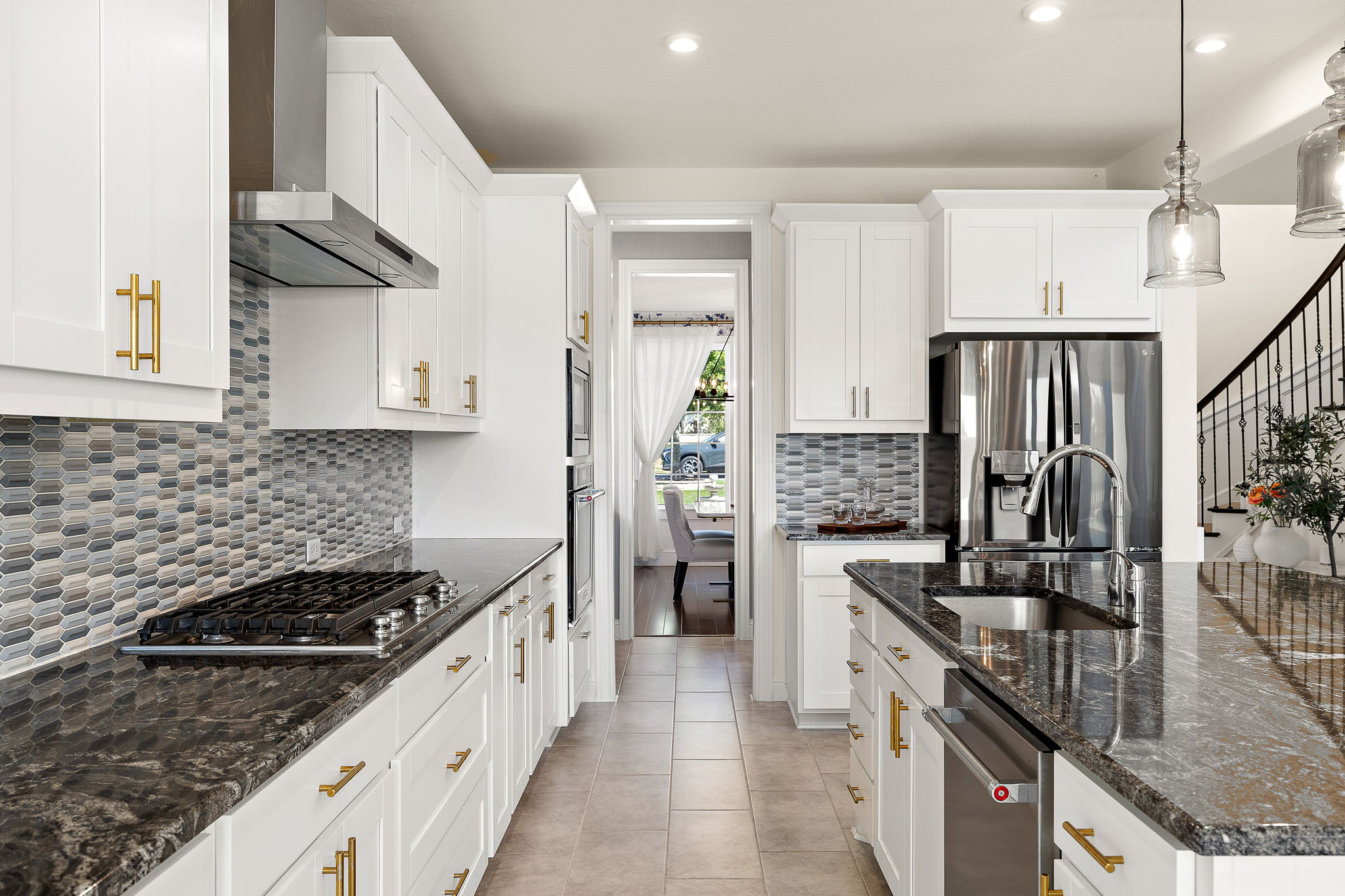 218 Encanto Place Austin, TX 78737 - Photo 15 of 40 a kitchen with stainless steel appliances granite countertop a sink stove and refrigerator