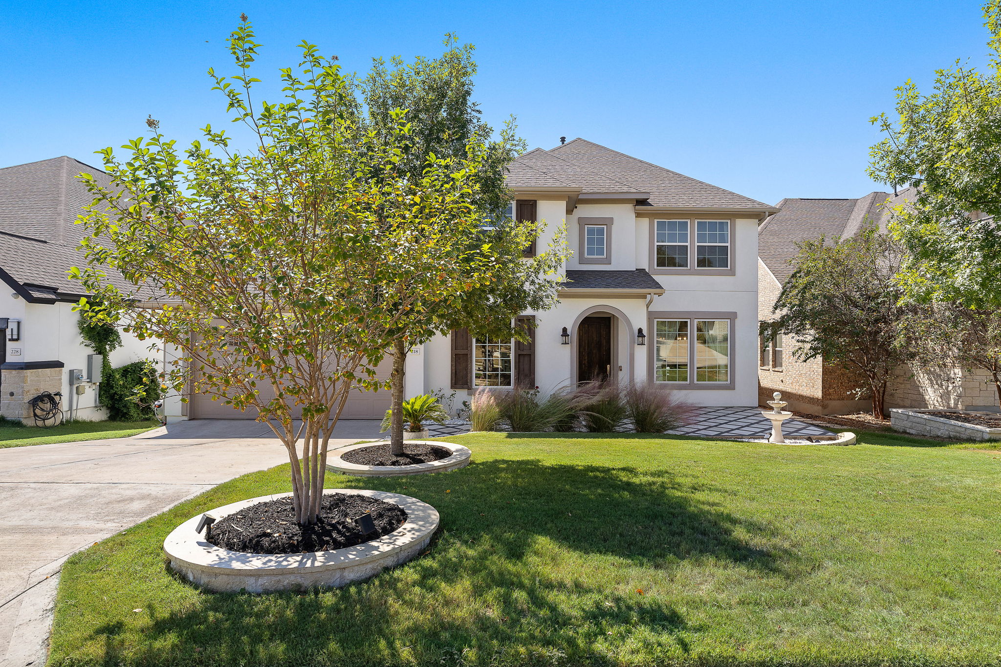 218 Encanto Place Austin, TX 78737 - Photo 2 of 40 a front view of a house with a yard