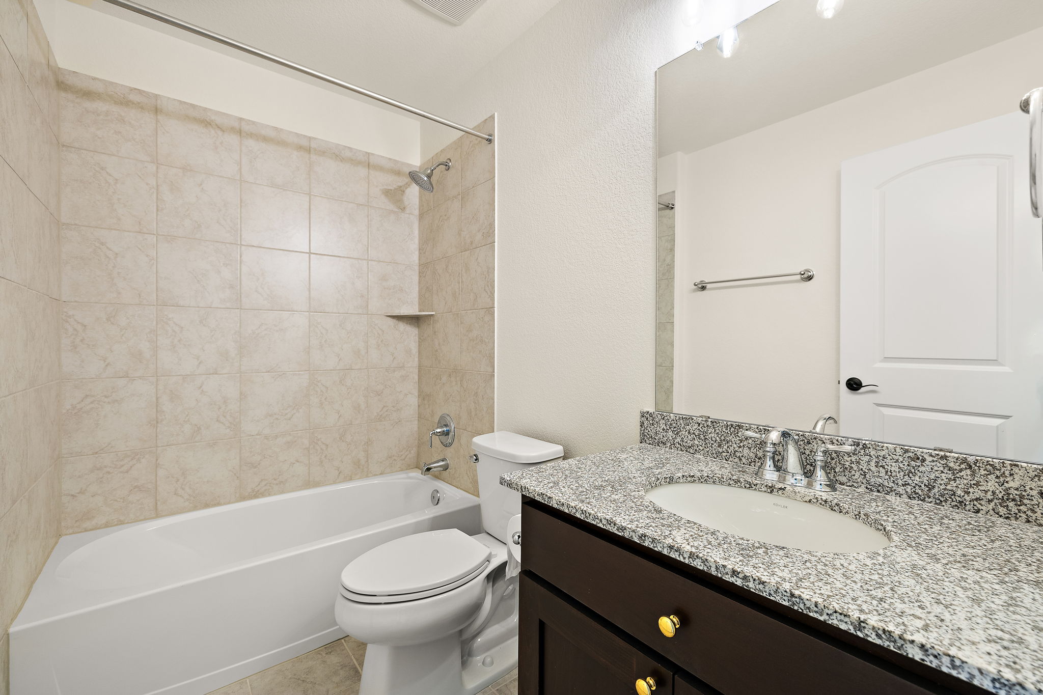 218 Encanto Place Austin, TX 78737 - Photo 30 of 40 a bathroom with a granite countertop sink a toilet a mirror a bathtub and shower