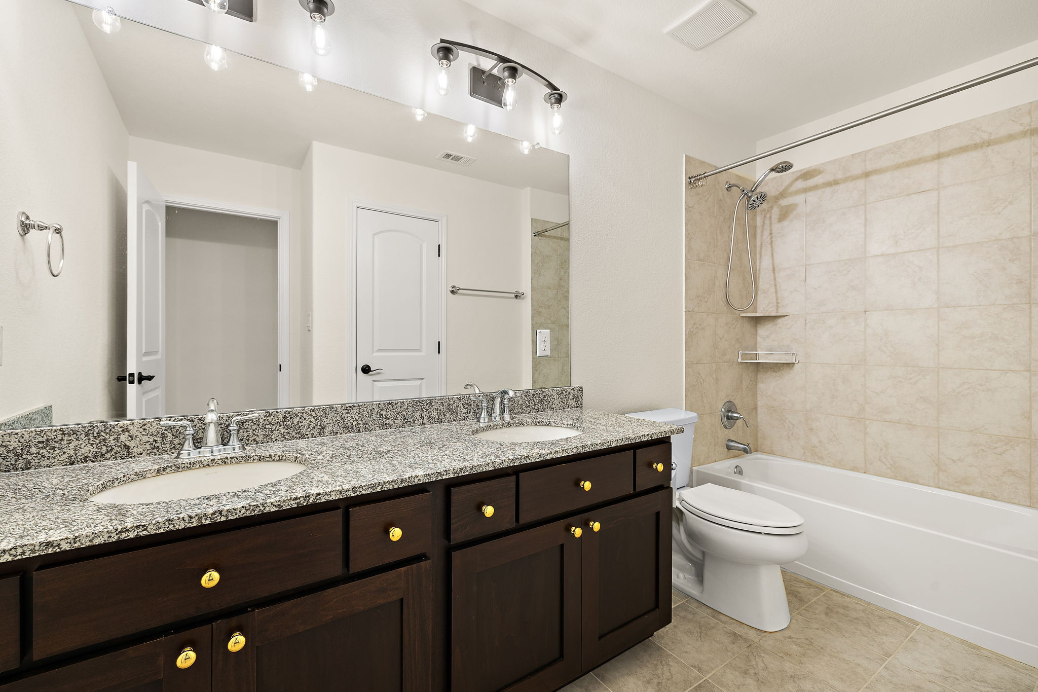 218 Encanto Place Austin, TX 78737 - Photo 32 of 39 a bathroom with a granite countertop sink toilet a large mirror a bathtub and shower