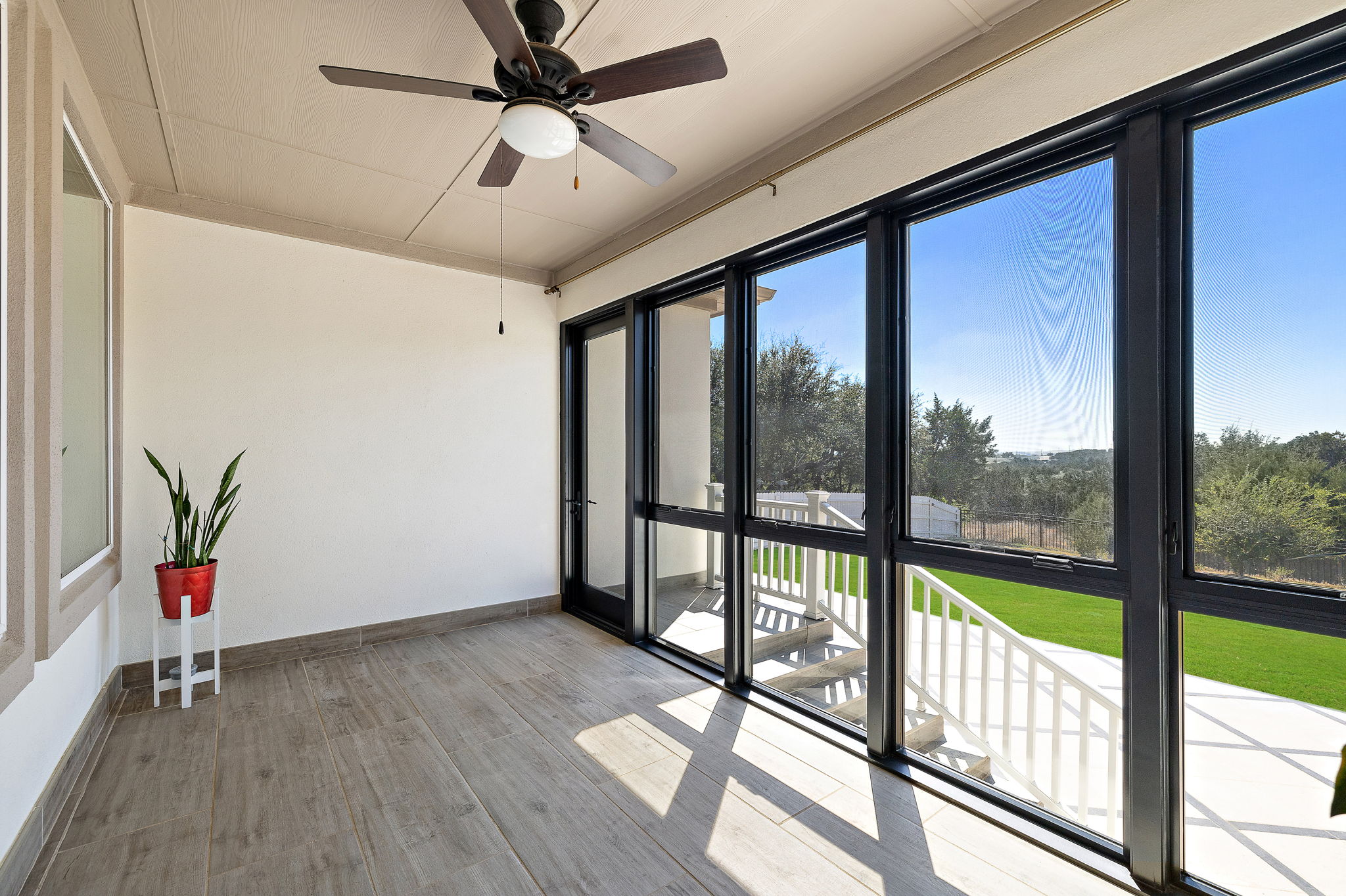 218 Encanto Place Austin, TX 78737 - Photo 35 of 39 a view of an empty room with wooden floor and a window