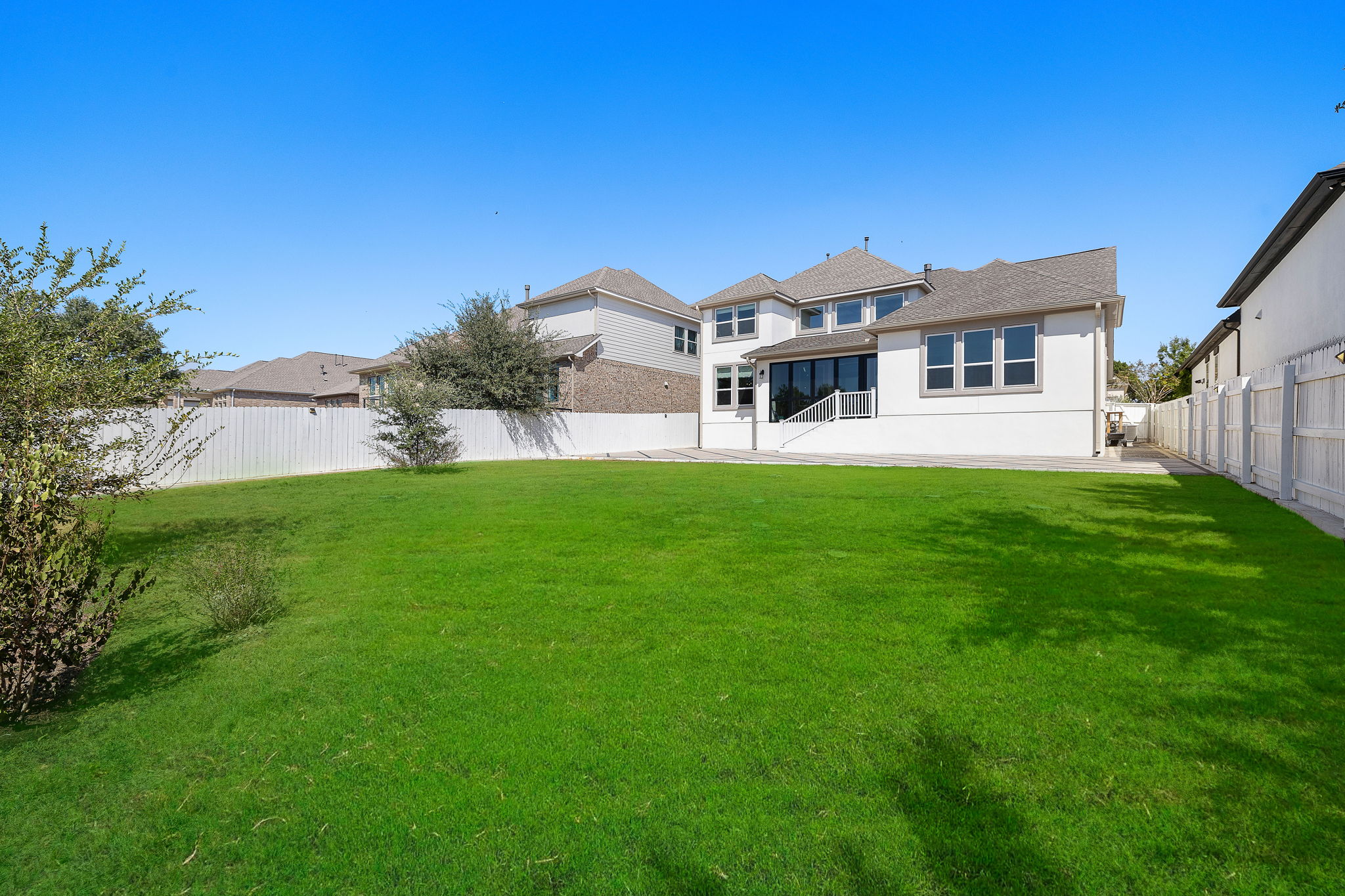 218 Encanto Place Austin, TX 78737 - Photo 40 of 40 a front view of a house with a garden and yard