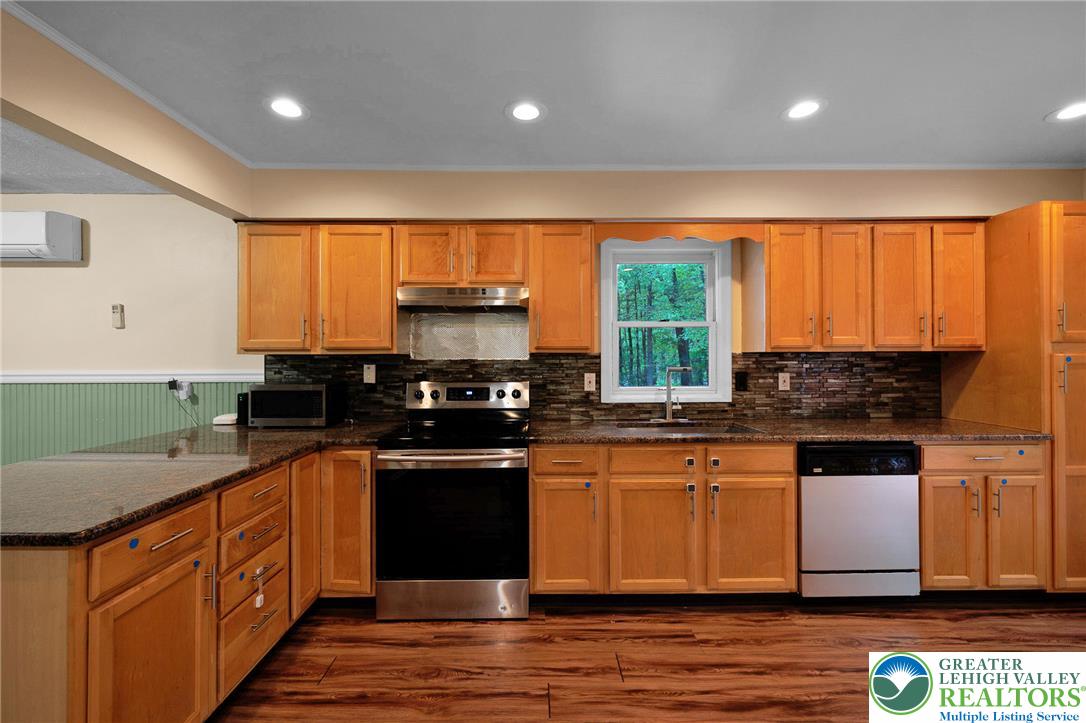 256 Sundance Road Effort, PA 18330 - Photo 21 of 83 a kitchen with stainless steel appliances granite countertop a stove a sink and a microwave