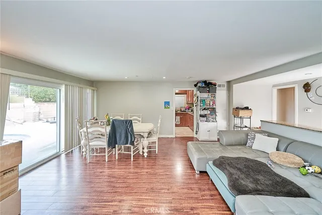 a living room with furniture wooden floor and a large window