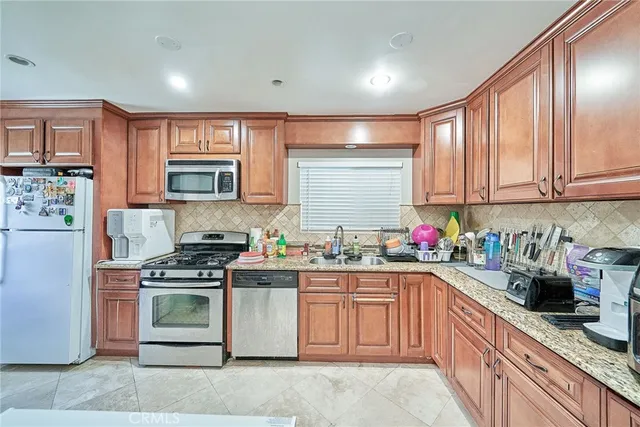 a kitchen with a sink stove top oven and cabinets