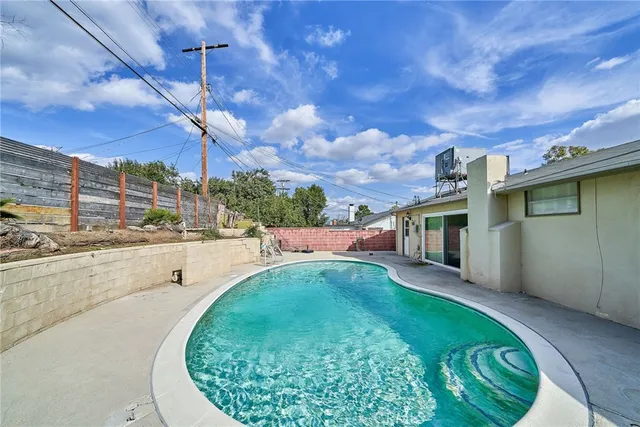 a view of a swimming pool with a patio