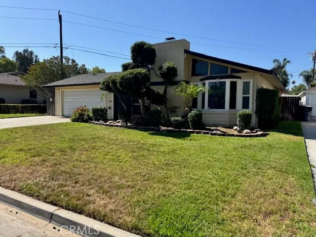 a view of a house with yard and sitting area