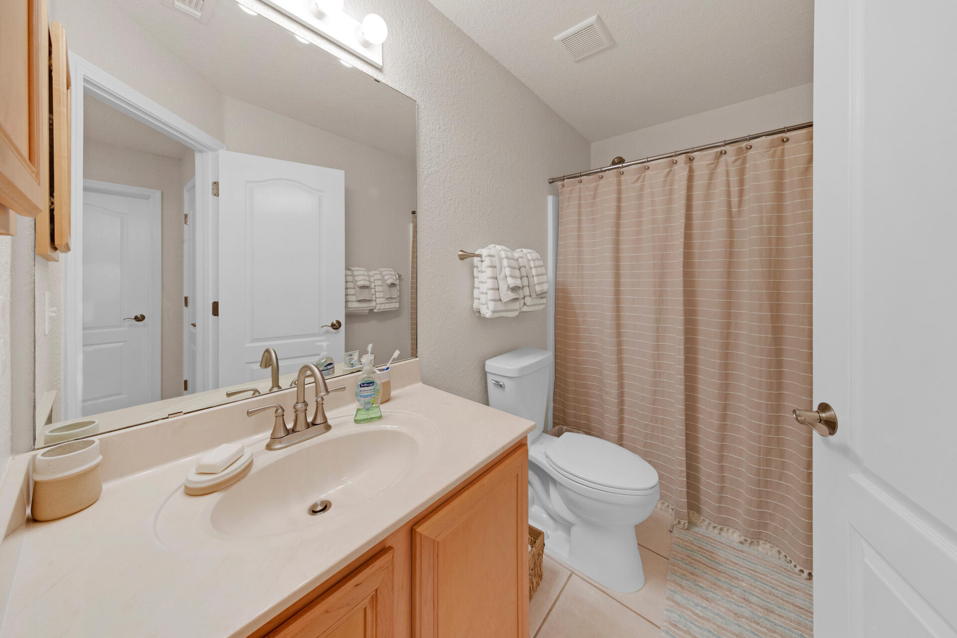 20 East Shipwreck Road Santa Rosa Beach, FL 32459 - Photo 26 of 37 a bathroom with a sink a toilet and shower curtain