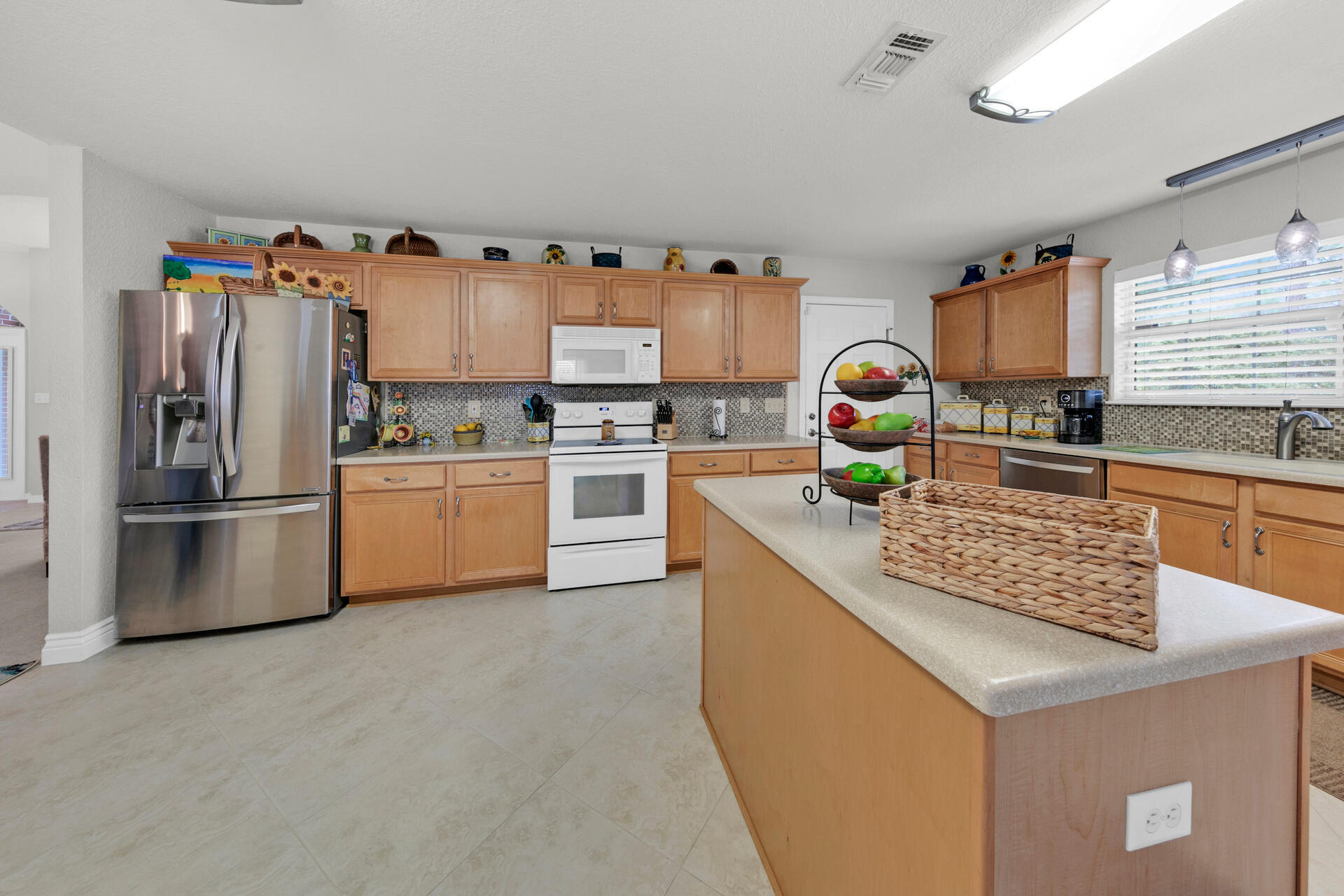 20 East Shipwreck Road Santa Rosa Beach, FL 32459 - Photo 5 of 37 a kitchen with stainless steel appliances granite countertop a sink stove and refrigerator