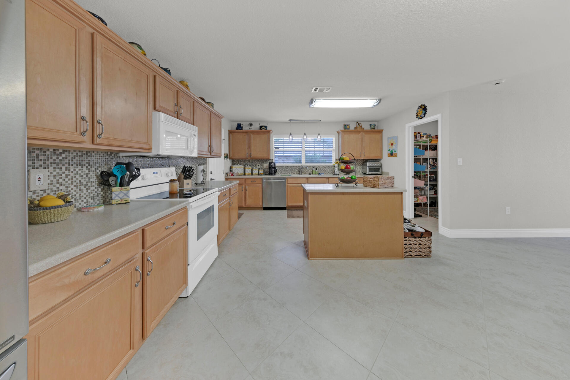20 East Shipwreck Road Santa Rosa Beach, FL 32459 - Photo 6 of 37 a kitchen with stainless steel appliances a sink a stove top oven a counter space and cabinets