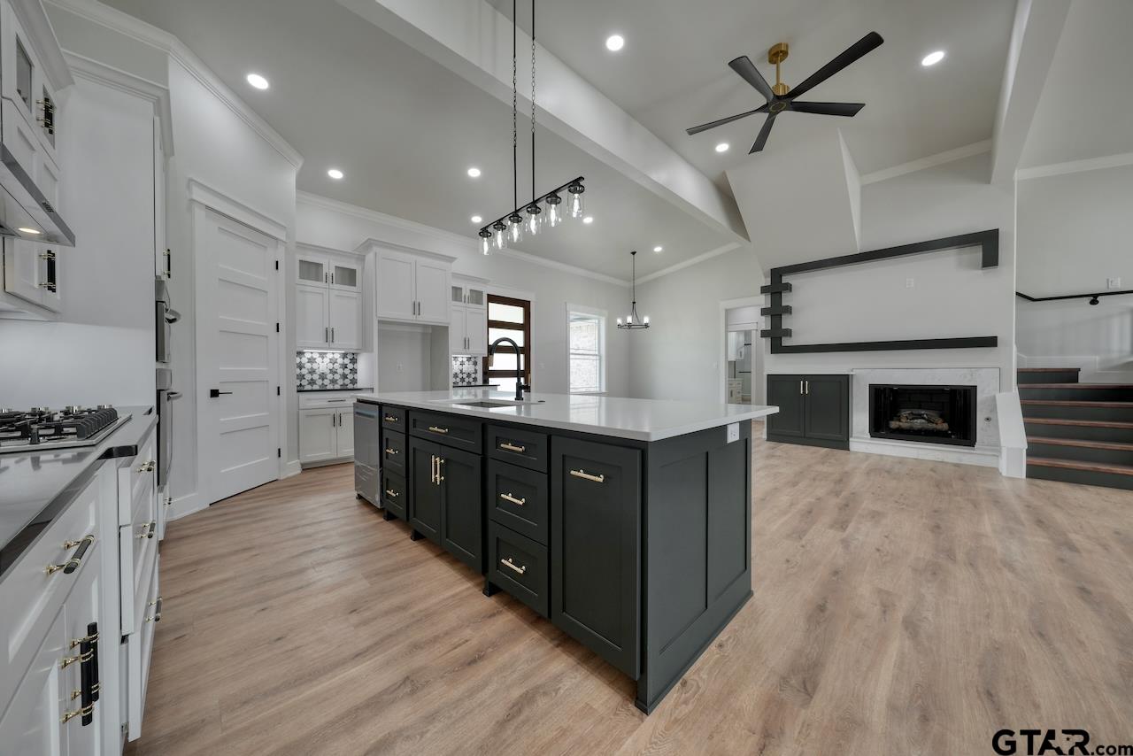 19383 Ridge Point Circle Lindale, TX 75771 - Photo 14 of 48 a large kitchen with stainless steel appliances a large counter top a stove and a sink