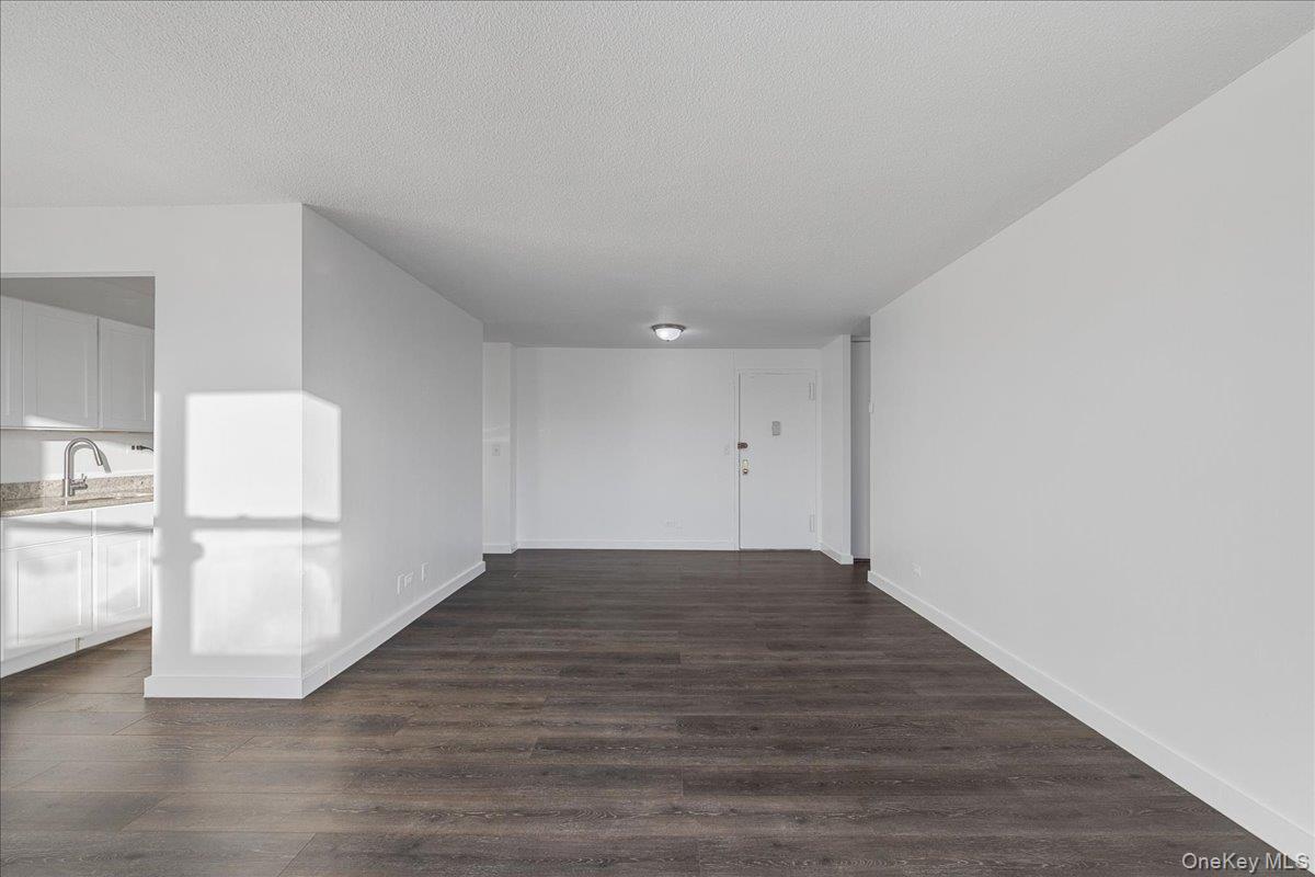 2550 Olinville Avenue, Unit 8H Bronx, NY 10467 - Photo 14 of 24 Hall featuring dark wood-type flooring and a textured ceiling