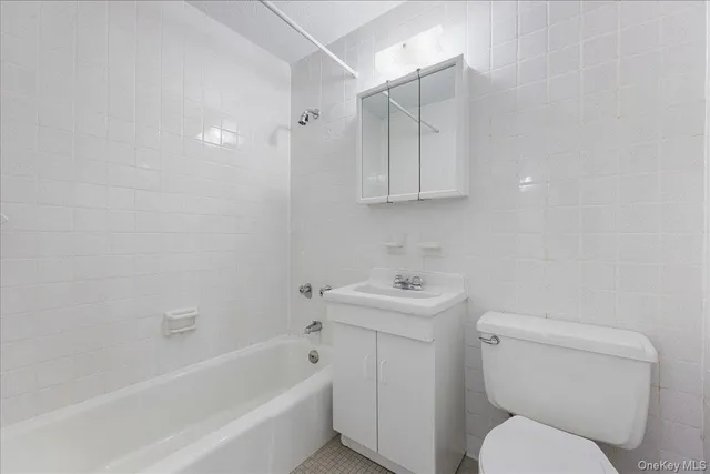 a bathroom with a toilet a sink and bathtub