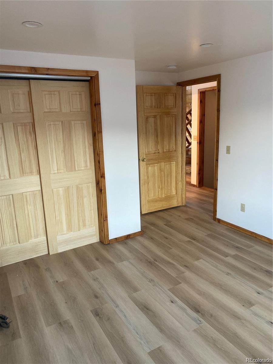 113 Nana Road Hartsel, CO 80449 - Photo 7 of 9 a view of an empty room with wooden floor and a window