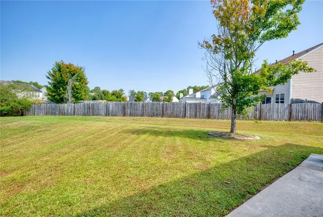 a view of a house with a yard and a garden