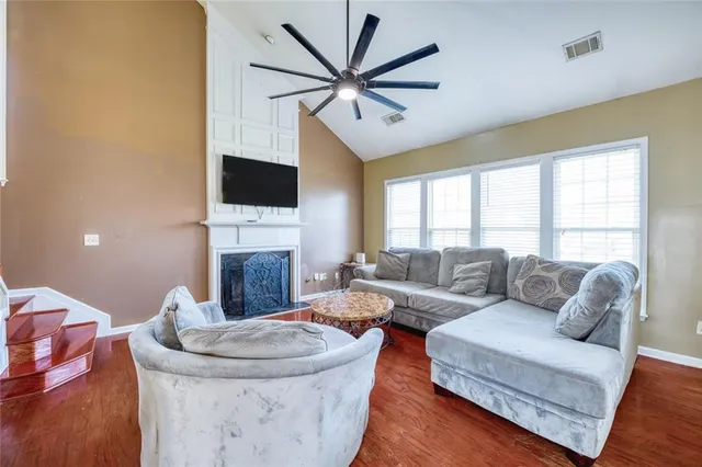 a living room with furniture a fireplace and a flat screen tv