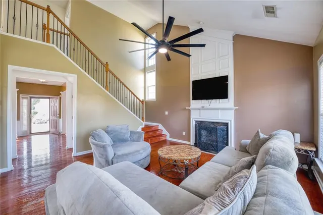 a living room with furniture a fireplace and a flat screen tv