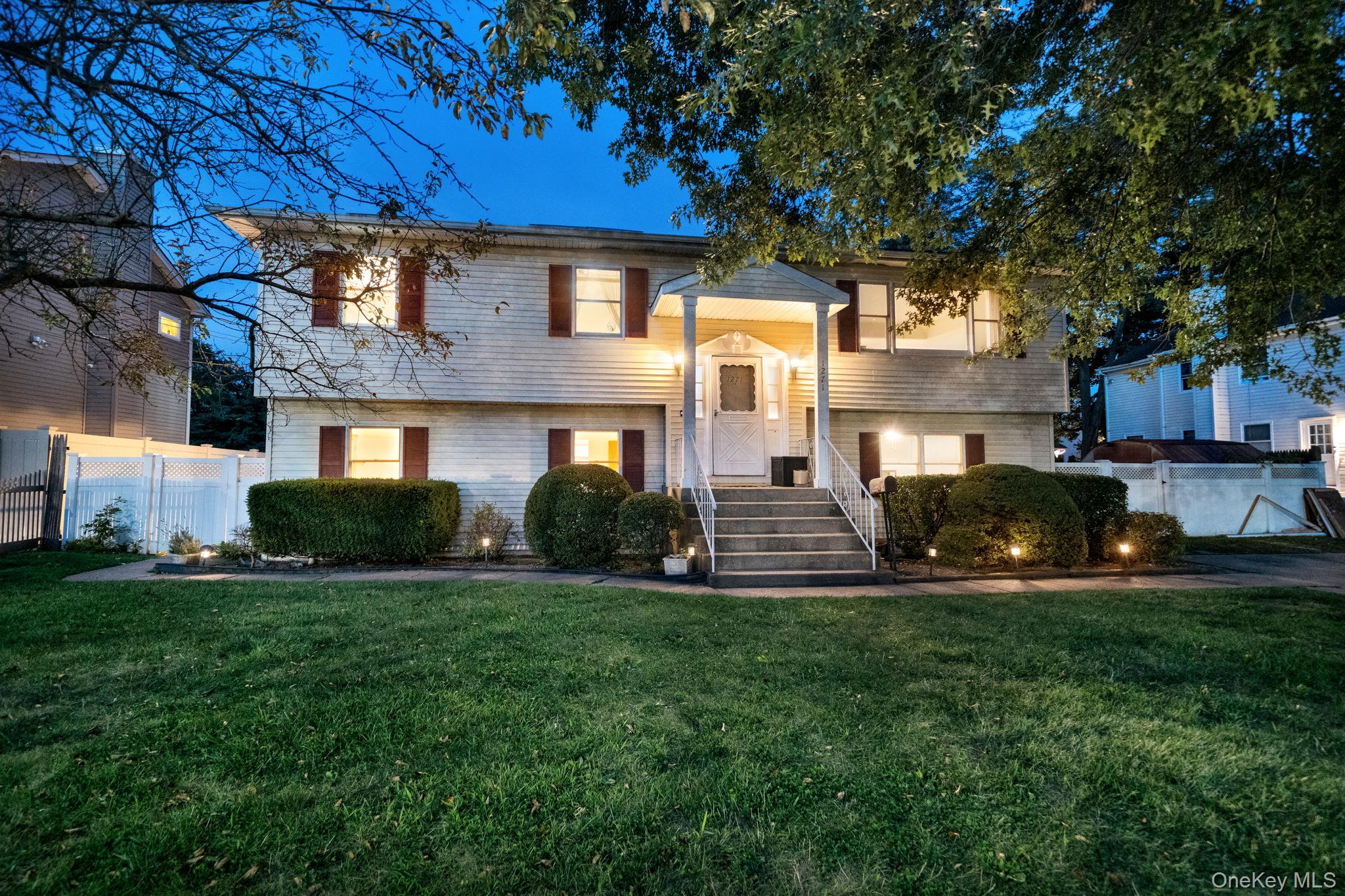 a view of house with backyard and sitting area